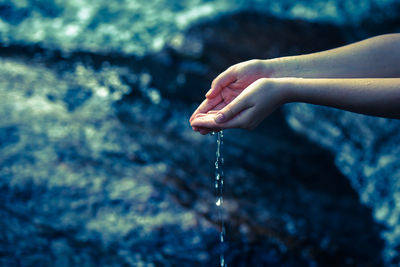 Woman pouring water in swimming pool