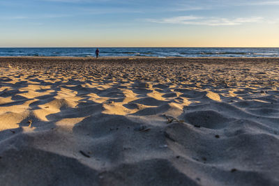 Scenic view of beach against sky during sunset