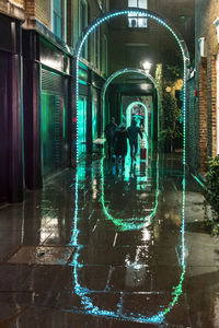 Man walking in illuminated building at night