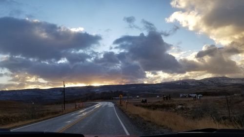 Road passing through landscape against sky