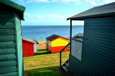 Hut on beach against sky