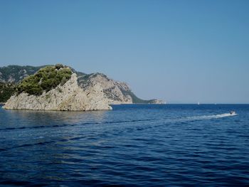 Scenic view of sea against clear blue sky