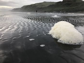 Scenic view of sea against mountain