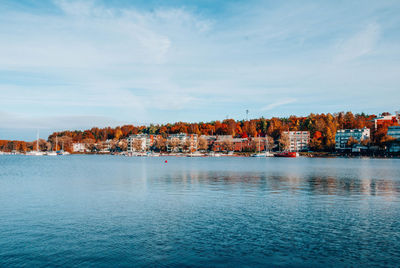 View of townscape by sea against sky