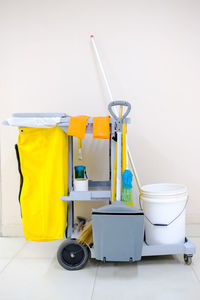 Close-up of garbage can against white wall