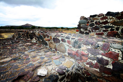 Built structure on rocks against the sky