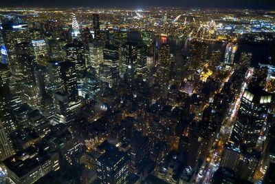 High angle view of city lit up at night