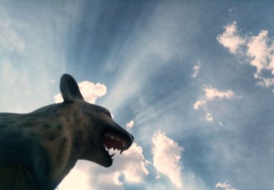 Low angle view of horse statue against sky