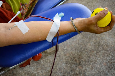 Blood donor at blood donation camp held with a bouncy ball holding in hand at balaji temple