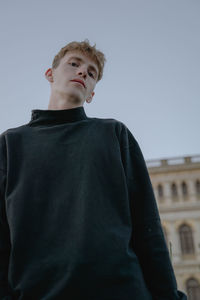 Portrait of man standing against sky