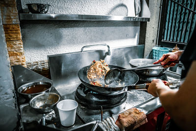 Cropped image of person preparing food