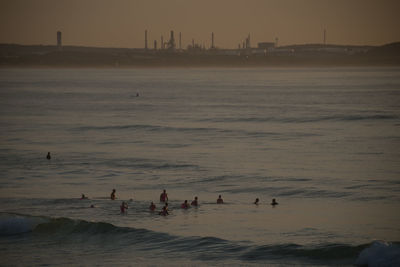 People on beach at sunset