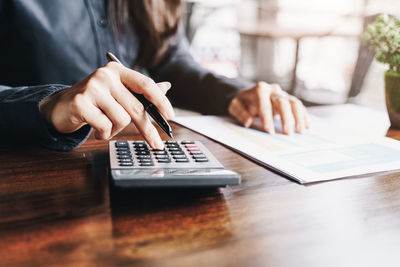 Midsection of woman working on table