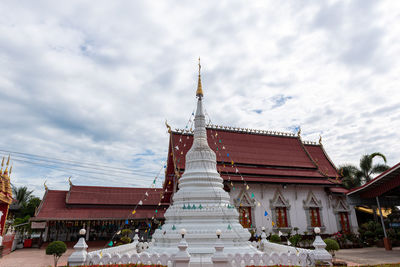 Low angle view of temple building against cloudy sky