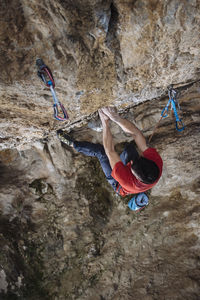 Aerial view of a climber on a hard sport climbing route in a cave