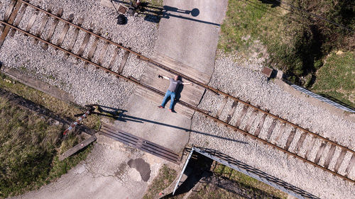 High angle view of man lying on railroad track
