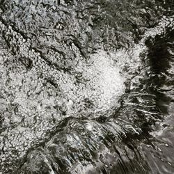 Full frame shot of water flowing through rocks