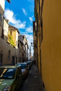 Street amidst buildings in city against sky