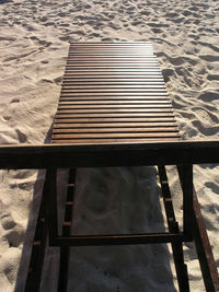 High angle view of empty bench on beach
