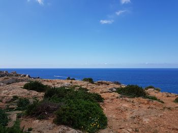 Scenic view of sea against blue sky