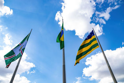 Low angle view of flags flag against sky