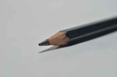 High angle view of pencils on table against white background