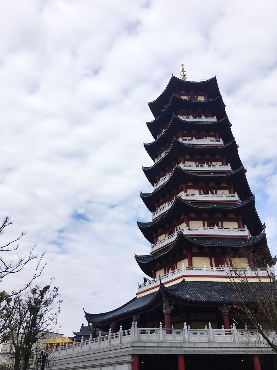 architecture, built structure, sky, religion, building exterior, place of worship, cloud - sky, spirituality, low angle view, travel destinations, day, outdoors, no people, tradition, cultures, flag, eaves