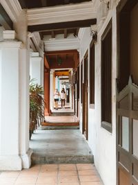 Women walking in corridor of building