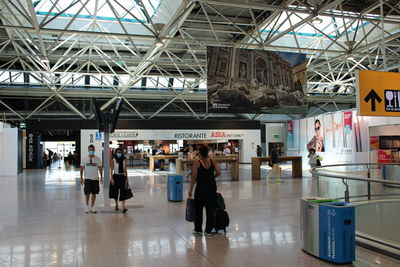 People walking on railroad station platform