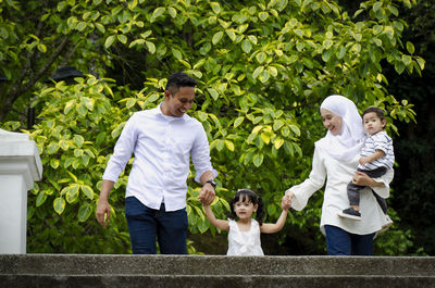 Full length of father with daughter against plants