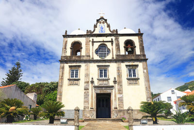 Low angle view of bell tower against sky