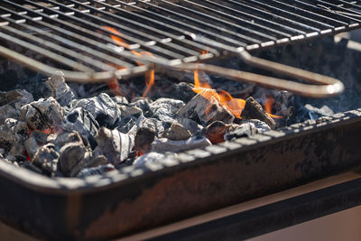 Charcoal with flame and grill.