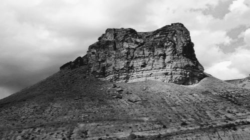 Low angle view of rock formations against sky