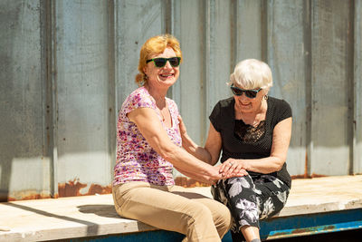 Two elderly women are happy to meet each other