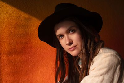 Portrait of young woman in hat sit alone in cafe