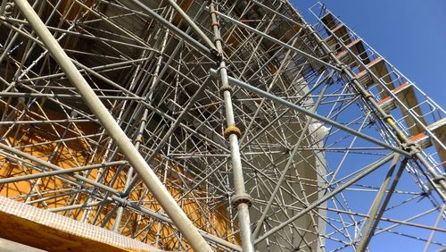 Low angle view of metallic structure against sky