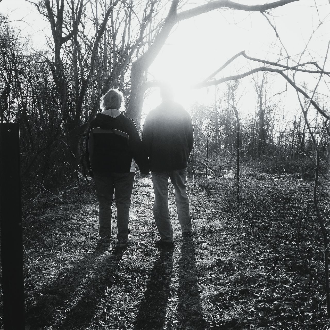 REAR VIEW OF COUPLE STANDING ON LAND