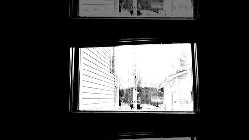 Silhouette of building seen through glass window