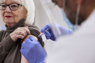 Senior woman getting vaccinated against covid-19