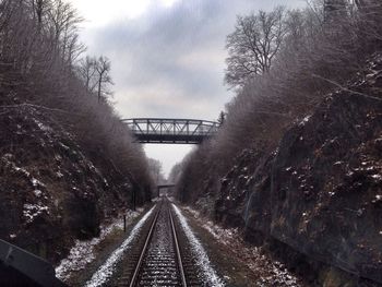 Railroad track against cloudy sky