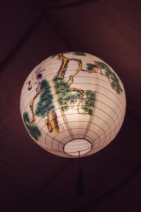 Low angle view of illuminated pendant lights hanging on ceiling