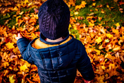 Rear view of man standing in forest during autumn