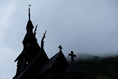 Low angle view of statues on building against sky