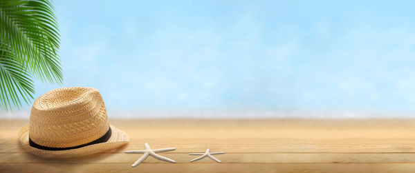 Close-up of hat on table against sky