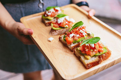 Close-up of hand holding food on table