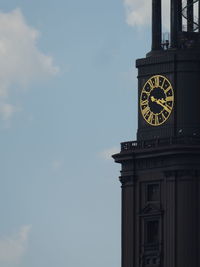 Low angle view of clock tower against sky