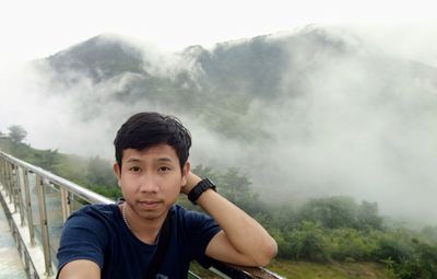 Man standing on mountain against sky