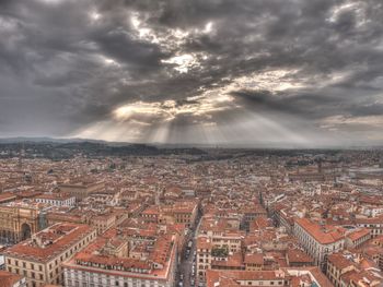 Aerial view of cityscape against storm clouds