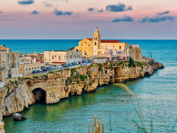 Scenic view of sea and buildings against sky