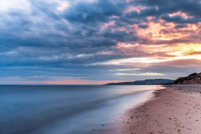 Scenic view of beach against sky during sunset